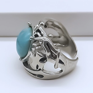 Detail of blue evil eye ring with cross carving and adjustable silver-tone metal band