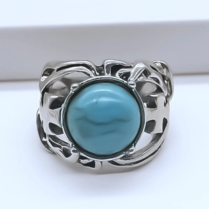 Detail of blue evil eye ring featuring punk style alloy band with hollow cross patterns