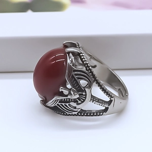 Macro side view showing the intricate eagle wing carvings on the vintage silver ring band