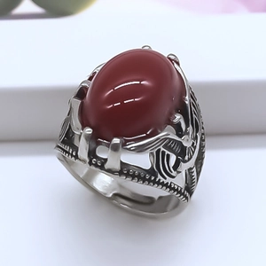 Retro hollowed silver ring with red oval stone and intricate ethnic carvings