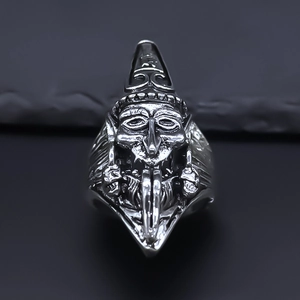 Macro shot of gothic deity carving on a vintage silver alloy ring with dark finish