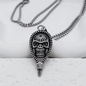 Macro shot of silver skull pendant with zipper edge and square box chain for men