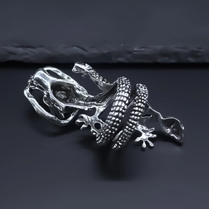 Vintage silver gothic lizard bone ring with punk skeleton details on dark surface