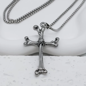 Gothic stainless steel bone cross necklace with square box chain on white stone base