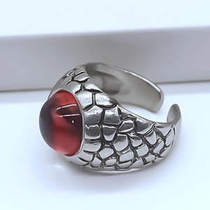 Detail of vintage dragon scale ring with a large red stone and adjustable silver band