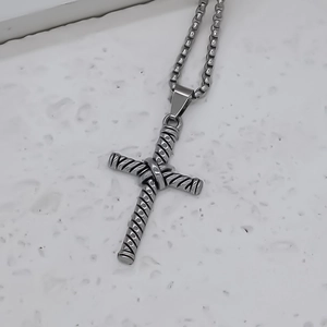Gros plan détaillé d'un pendentif croix argenté avec texture de corde sur une chaîne