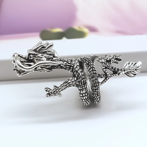 Detailed close-up of a vintage dragon ring with oxidized silver scales and textures