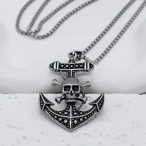 Macro view of a silver stainless steel anchor skull pendant with an oxidized finish