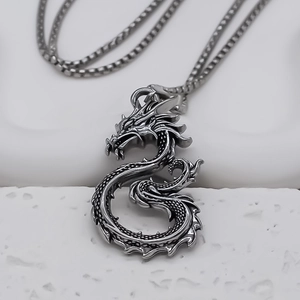 Close-up of a silver dragon pendant necklace with intricate retro metal scales and textures