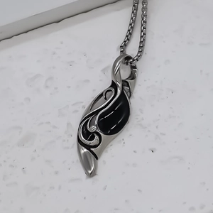 Collana con ciondolo punk con pietra nera e totem a fiamma inciso sulla superficie della pietra