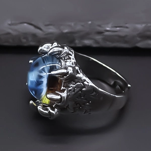 Macro shot of punk dragon claw ring with blue eye stone and vintage silver finish