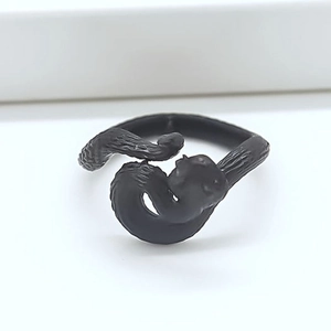 Detailed view of the matte black snake ring with textured scales in gothic style