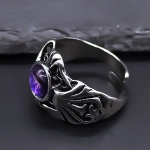 Detailed close-up of retro gothic open ring with purple dragon eye stone and bat wings