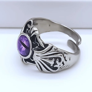 Detail view of gothic dragon wing ring with purple evil eye stone in silver finish