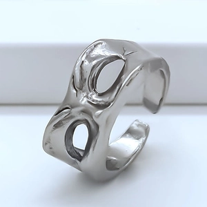 Detailed view of silver open ring with organic lava texture and double oval cutouts