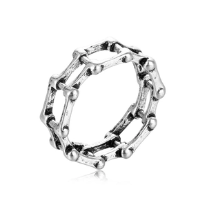Detail view of gothic skeletal chain link ring in vintage silver finish on white backdrop