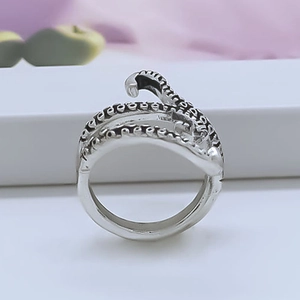 Detailed close-up of retro octopus tentacle ring with vintage oxidized silver texture