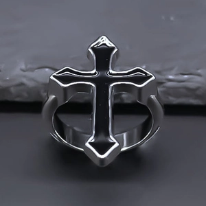 Gothic silver cross ring in punk style with black enamel inlay on stone background