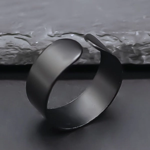 Macro view of matte black wide open ring with industrial minimalist design finish