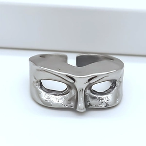 Detailed macro view of the silver adjustable mask-shaped open metal ring with matte finish