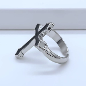 Macro detail of gothic silver cross ring with black enamel and adjustable open band