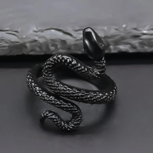 Detail of vintage black snake open ring featuring intricate scales and gothic metal texture