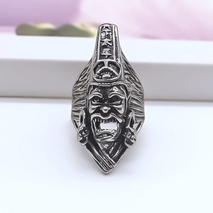 Macro shot of retro alloy ring showing traditional deity face and engraved characters