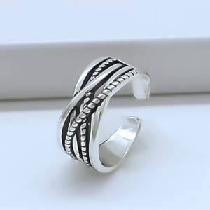 Detailed close-up of retro silver interwoven multi-layer ring with braided texture