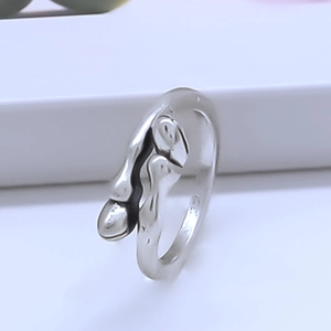Macro detail of silver adjustable ring with artistic abstract melting face design