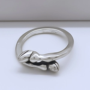 Macro detail of vintage silver alloy ring with unique interlaced animal hoof design