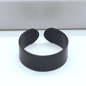 Minimalist matte black open ring with a smooth industrial finish and rounded ends