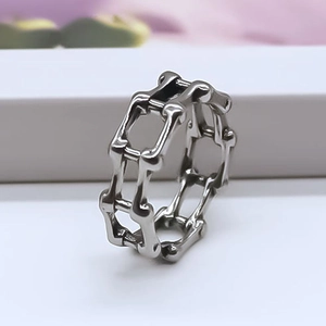 Detailed view of irregular hollow chain ring in silver finish with industrial punk style