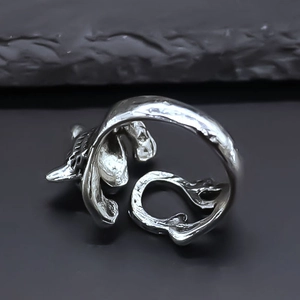 Macro shot of vintage silver animal ring with engraved textures and adjustable opening band