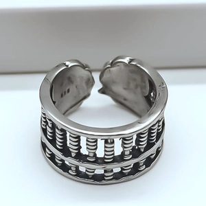 Macro detail of silver abacus ring featuring a double-row movable bead design