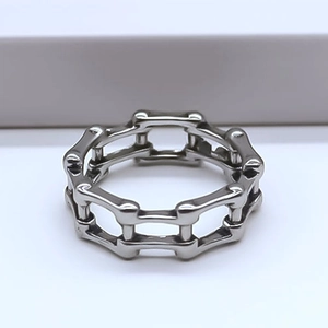 Macro shot of industrial style link chain ring in polished silver stainless steel
