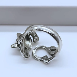 Close-up of silver leopard head ring with adjustable open band and animal texture
