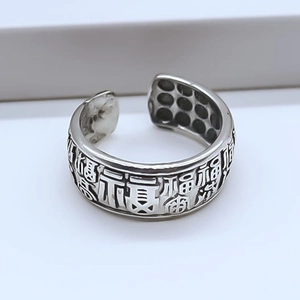 Detail of vintage silver open ring with engraved Fu character and blackened finish