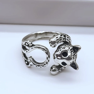 Macro shot of vintage silver leopard ring with detailed black spots and open band design