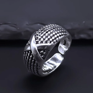 Detailed close-up of retro silver adjustable ring featuring textured weave and dot patterns