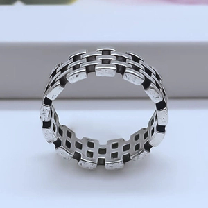 Detailed close-up of retro irregular alloy ring featuring industrial brick texture and hollow design