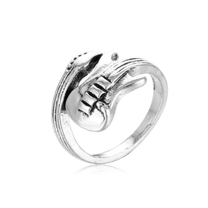Macro detail of retro guitar shaped open ring with vintage silver finish and texture