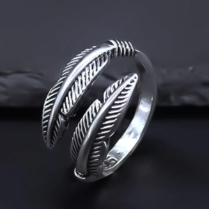 Macro shot of vintage silver feather ring showing detailed texture and adjustable opening