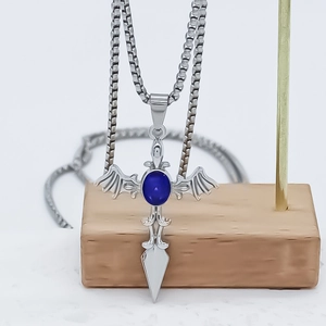 Retro hip-hop cross necklace featuring bat wings and a deep blue gemstone inlay
