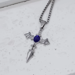 Gothic silver cross necklace with bat wings and deep blue oval gemstone detail