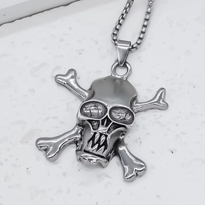 Macro shot of silver pirate skull and crossbones pendant with robust box chain link