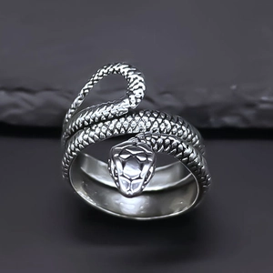 Detailed close-up of a silver snake ring showing intricate scales and metallic texture