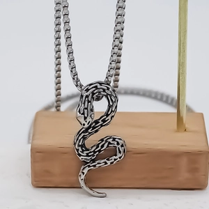Silver snake pendant necklace with realistic scale texture on a classic box chain