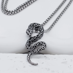 Vintage silver snake pendant necklace with detailed scales on a square pearl chain