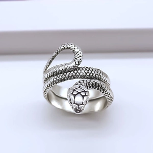 Detail of silver snake ring featuring realistic 3D scale texture and cobra head design