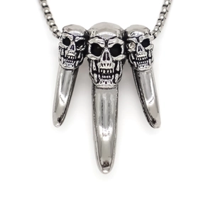 Detail view of silver punk necklace featuring triple skulls and sharp claw pendants